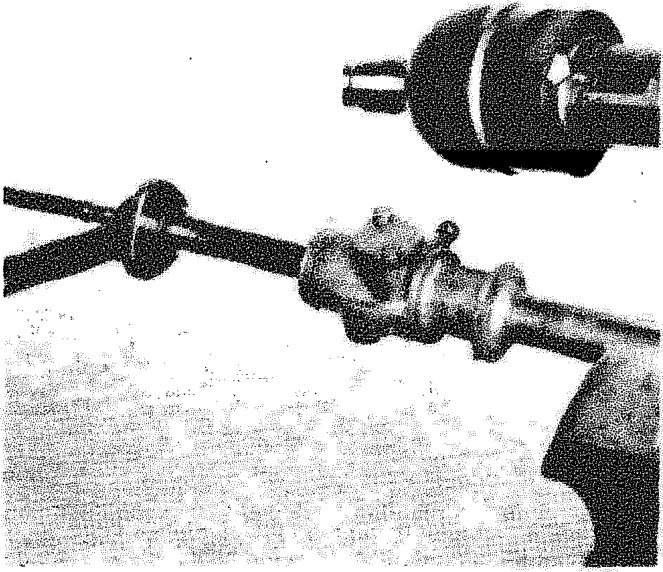 A close-up view of a ball joint on a steering track rod, showing the seal and nut.