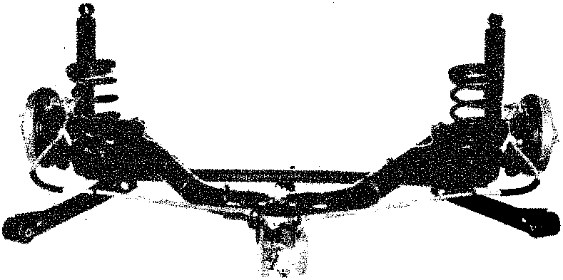 Complete rear suspension assembly removed from vehicle, showing axle, springs and dampers
