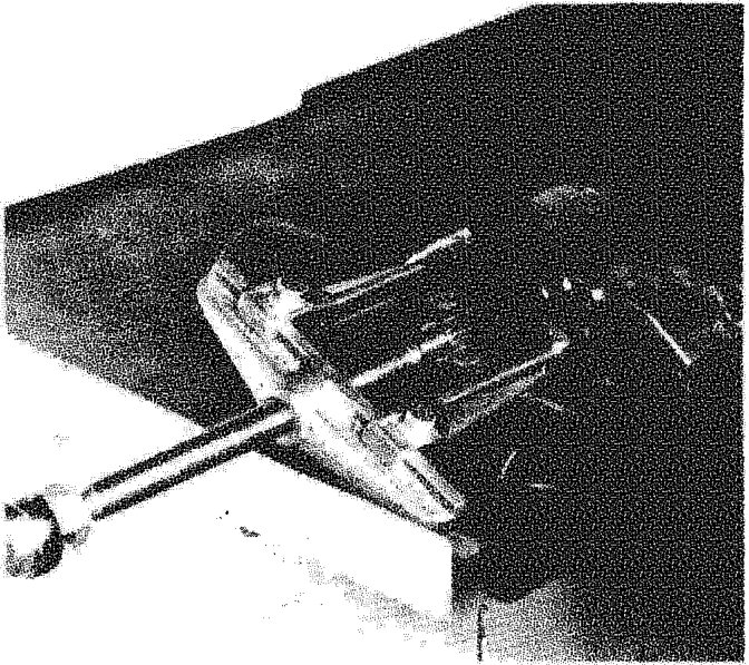 Removing flexible mounting from central propeller shaft using a tool to separate the joint.