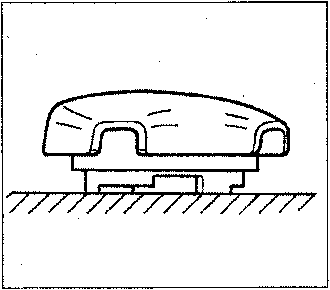 Diagram of an airbag module resting on a flat surface, showing the metal backing facing down