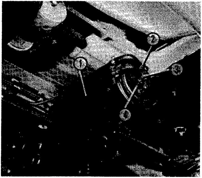 Photograph of active charcoal filter assembly under vehicle with callout numbers 1, 2, 3, and 4