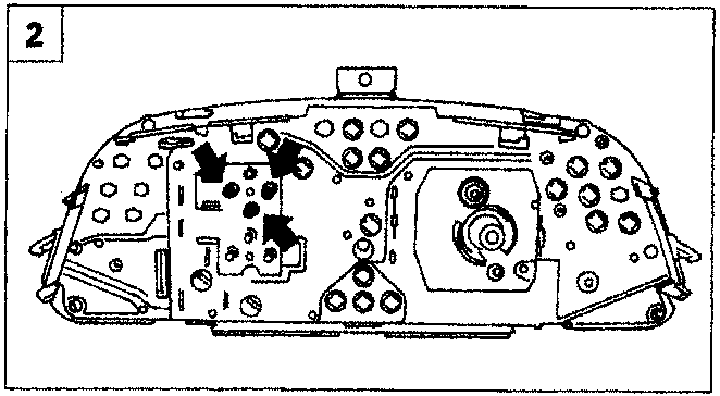 Rear view of the instrument panel showing the fuel gauge and arrowed screws at the bottom
