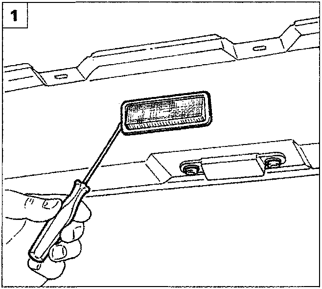 A screwdriver being used to withdraw a rectangular courtesy light from its seating in the vehicle interior trim.