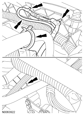 Step 19: If equipped, detach the engine block heater harness retainers from the radiator support and the A/C suction tub