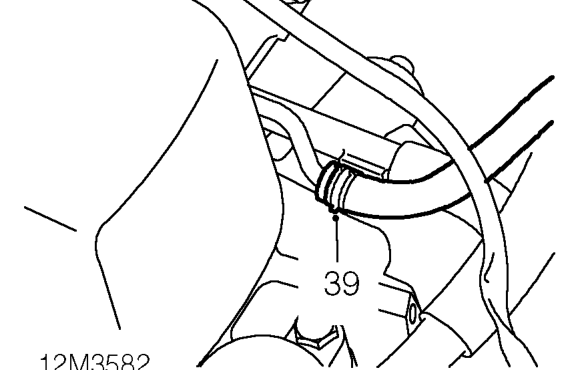 Release clips and disconnect heater hoses.