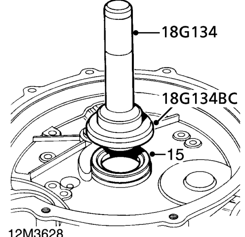 Lubricate new flywheel housing oil seal.