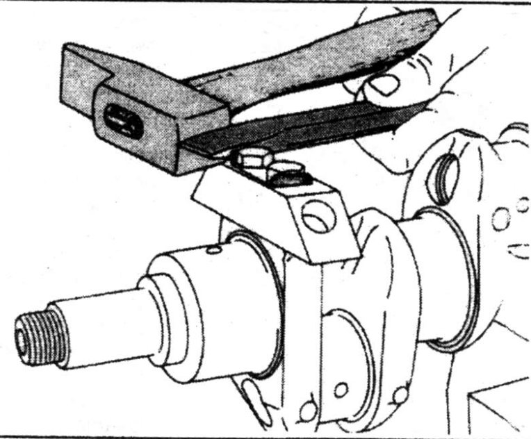 The locking plates for the crankshaft counter weights are locked with a chisel and a hammer as shown.