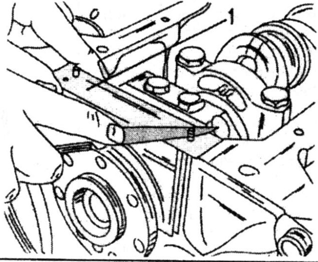 The protruding ends of both seals must be cut-off with a sharp knife. The sheet metal piece (1) is placed in position as shown.