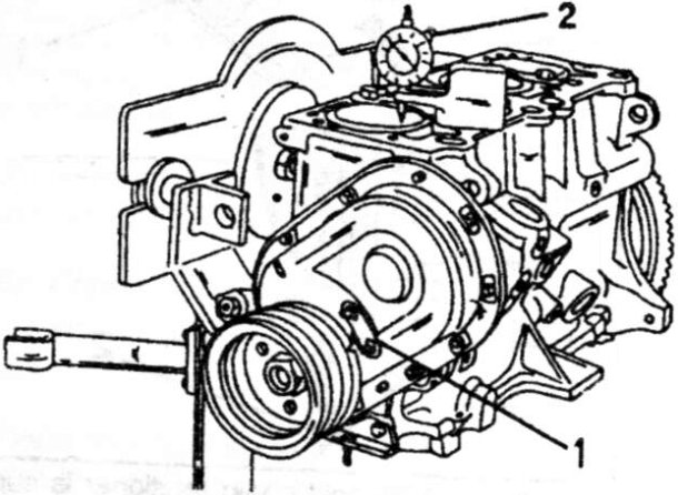 To fit the timing plate (1) in the correct position, use a dial gauge (2) to set the No. 1 piston to top dead centre. The zero on the timing plate must be in line with the notch in the crankshaft pulley.