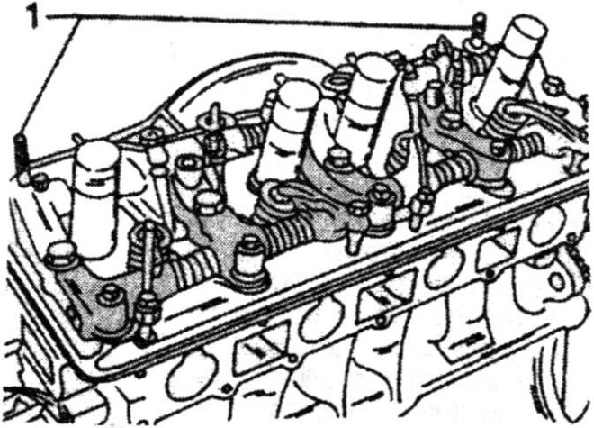 Cylinder head and rocker shaft assembly fitted to the engine. The two locating pins are fitted to positions (1).