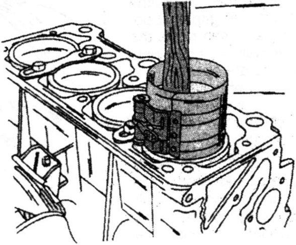 Fitting a piston with a piston ring clamp