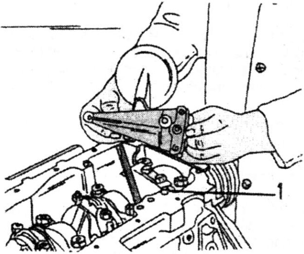 Removal of oil pump showing hands using pliers on a shaft near engine block with part labeled '1' indicating dowel sleeve