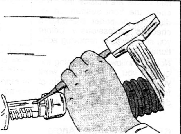Hand using a tool to secure the track rod ball joint housing.