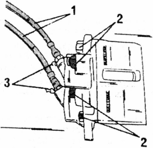 View of the fitted caliper showing brake hoses, bolts and bleeder screws