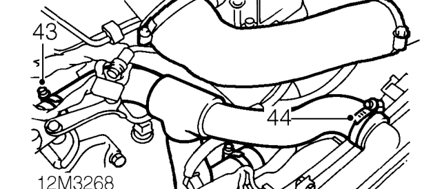All models – Release harness from 2 clips on camshaft upper front cover and move harness aside.