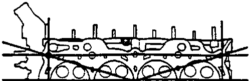 Cylinder head with straight edges placed across it to measure warpage along edges and centre