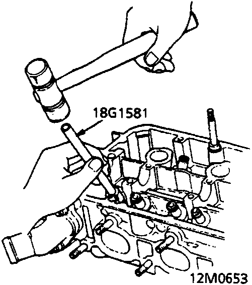 Diagram showing a tool driving a new valve guide into the cylinder head with a hammer