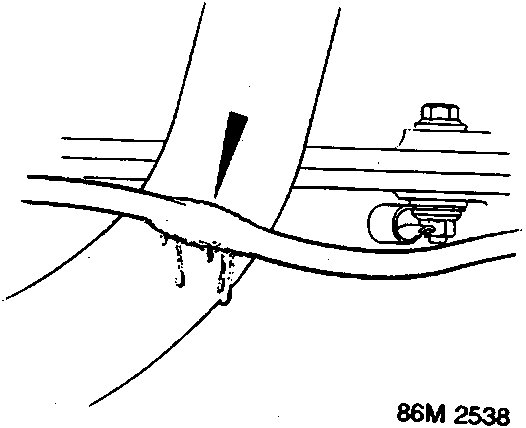 Diagram showing a wiring harness rubbing against a metal component, causing damage to the insulation