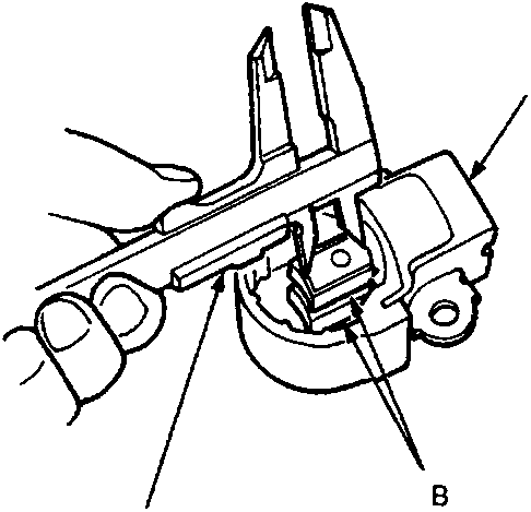 Close-up view of a vernier caliper measuring the length of an alternator brush held in its holder