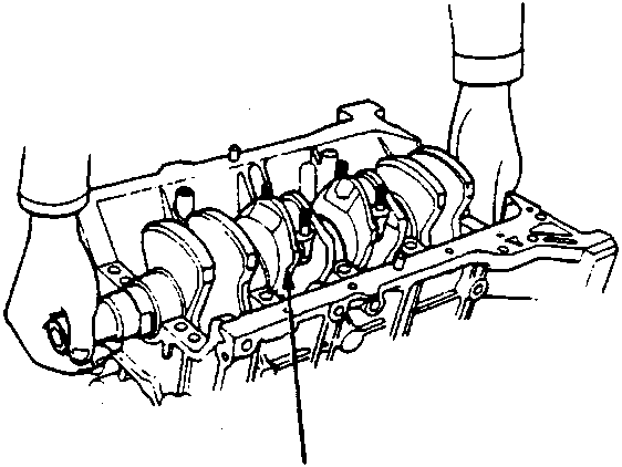 Crankshaft being lifted out of the engine block, labeled A