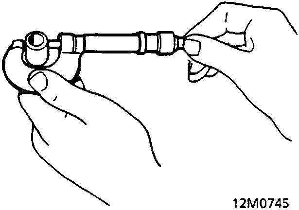 A hand holding a gudgeon pin while measuring its diameter with a micrometer (12M0745).
