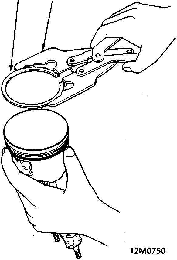 Diagram showing hands using a ring expander tool to remove a piston ring from a piston