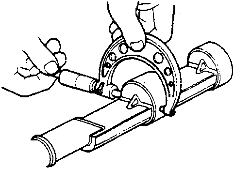 Hands inspecting the balancer shaft journal and bearing