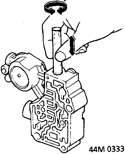 Diagram showing a hand twisting a rolled piece of abrasive paper inside a valve bore of a valve body