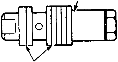Close-up of the flow control valve showing grooves to check for damage