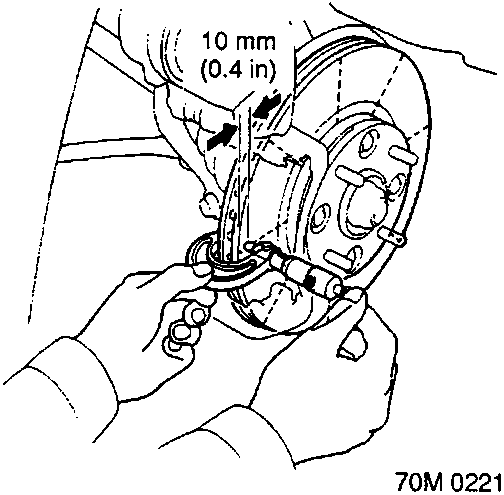 Diagram showing hands using a micrometer to measure the thickness of a brake disc at a point 10 mm (0.4 in) in from the outer edge.