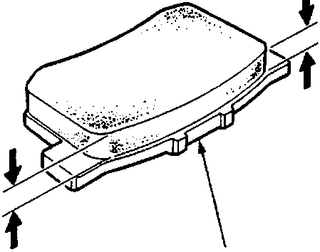 Close-up of a brake pad lining and backing plate with arrows indicating measurement points