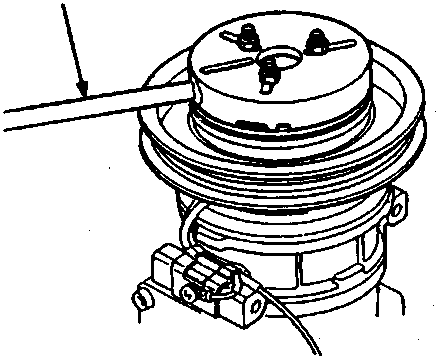 Diagram showing the removal of the centre bolt from the A/C clutch pressure plate using a holder