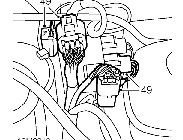 Release clip securing inertia switch harness to mounting bracket.