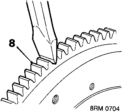 Diagram showing cold chisel applied to root of starter ring gear tooth on flywheel