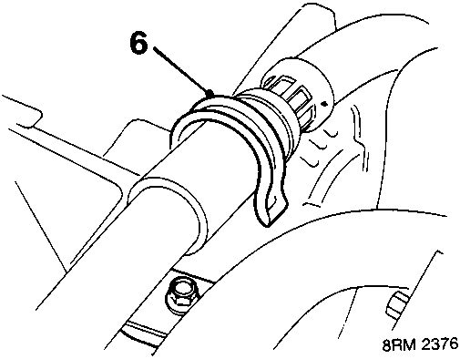 Close-up detail of a power steering hose secured by a clip on a bracket