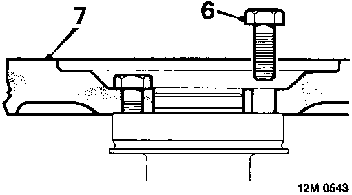 Diagram showing a bolt being used to remove the flywheel from the crankshaft