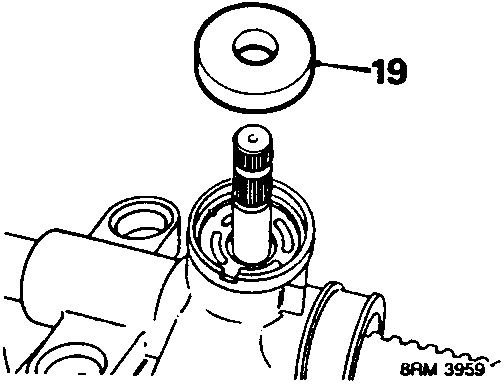 Diagram showing the pinion seal being removed from the steering rack housing, with callout number 19.